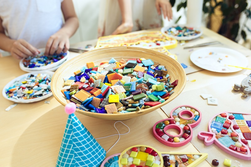 mosaic puzzle art for kids, children's creative game. two sisters are playing mosaic