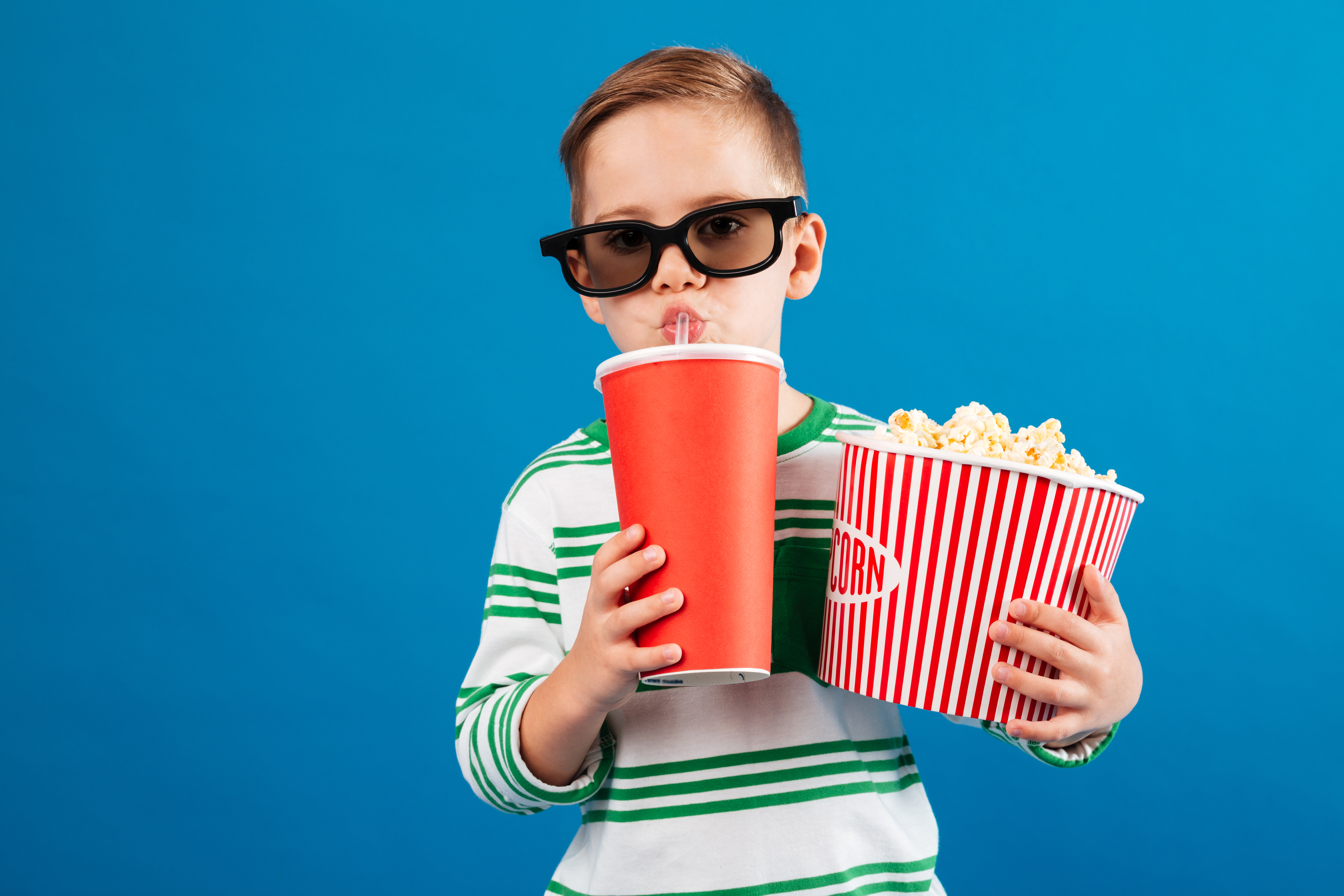 Cool Young boy in eyeglasses preparing to watch the film