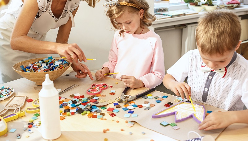 mosaic puzzle art for kids, children's creative game. two sisters are playing mosaic