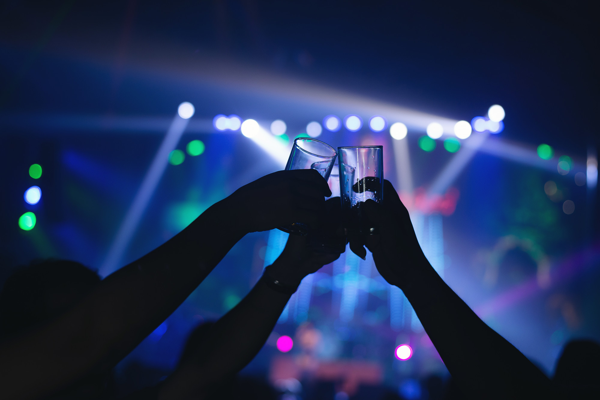 friends-clinking-drink-glasses-modern-bar