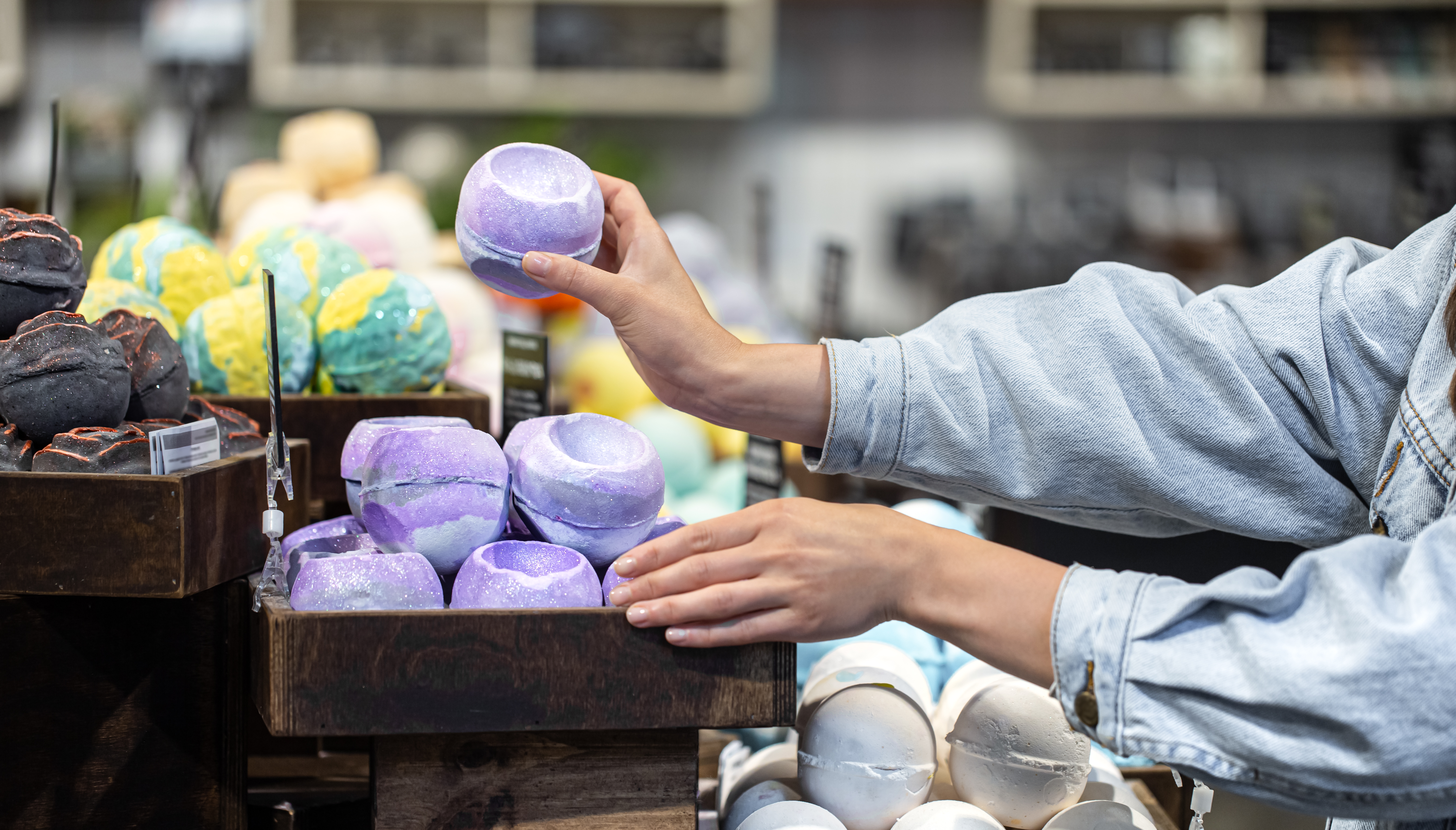 Handmade colorful organic bath bombs on showcase.